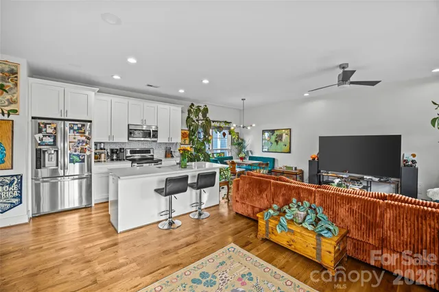 a living room with furniture a rug and a flat screen tv