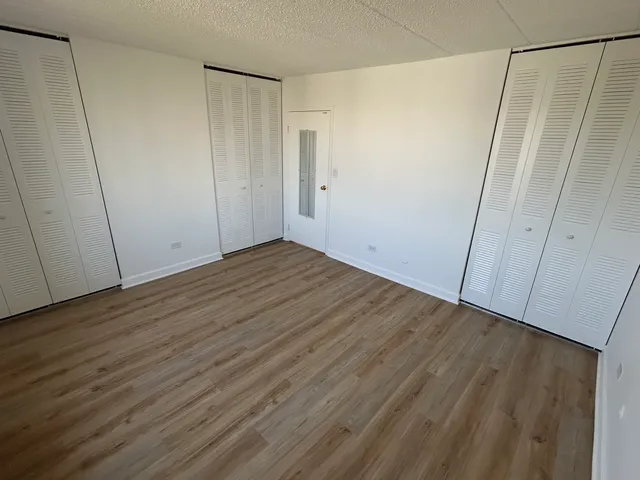 an empty room with wooden floor