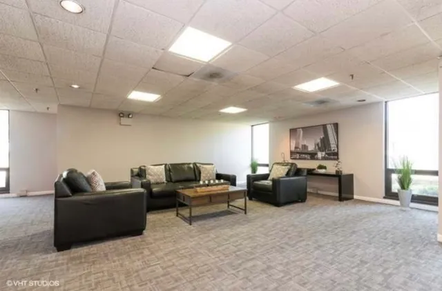a kitchen with a refrigerator and white cabinets