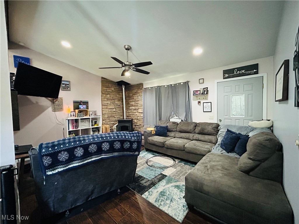 5636 Laskey Road Rome, OH 44085 - Photo 5 of 29 Living room featuring a wood stove, wood finished floors, a ceiling fan, and vaulted ceiling