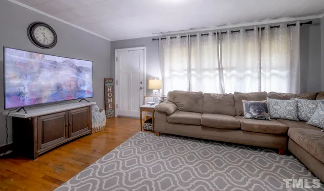 a living room with furniture a window and a fireplace
