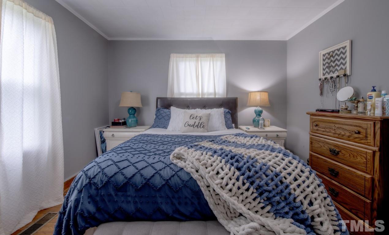 3795 Seven Paths Road Louisburg, NC 27549 - Photo 18 of 21 a bedroom with a bed and a window