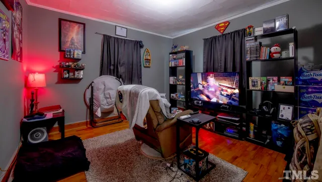 a room with gym equipment and a flat screen tv