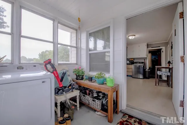 a view of entryway with workspace and livingroom view