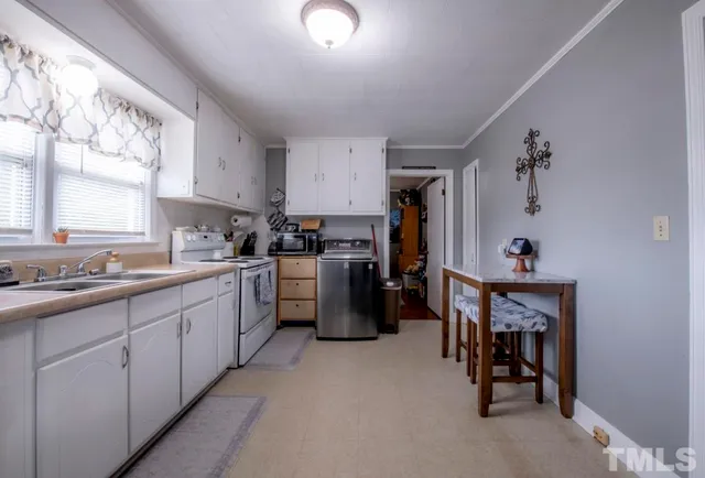 a kitchen with cabinets and window