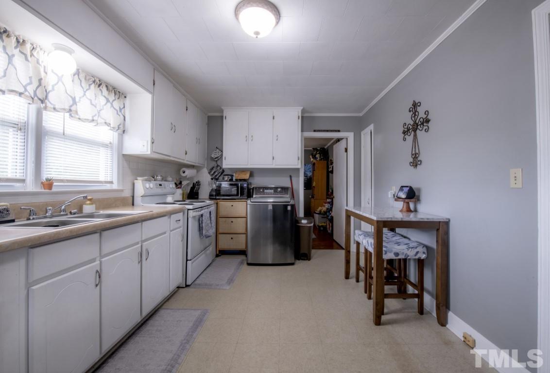 3795 Seven Paths Road Louisburg, NC 27549 - Photo 6 of 21 a kitchen with cabinets and window