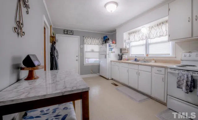 a kitchen with a sink dishwasher and a refrigerator