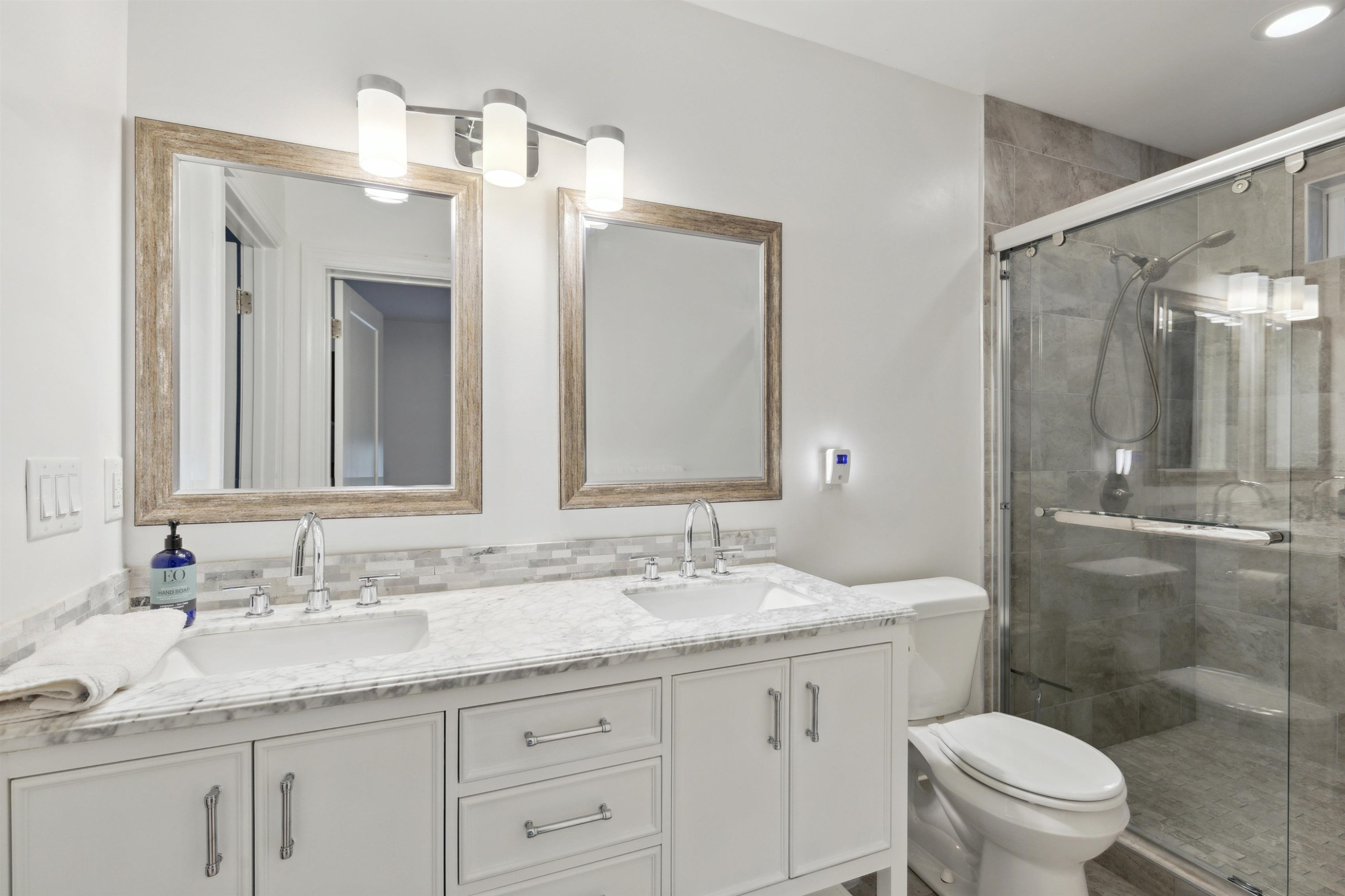 1203 North Miami Boulevard Durham, NC 27703 - Photo 14 of 22 a bathroom with a granite countertop sink a toilet and a mirror