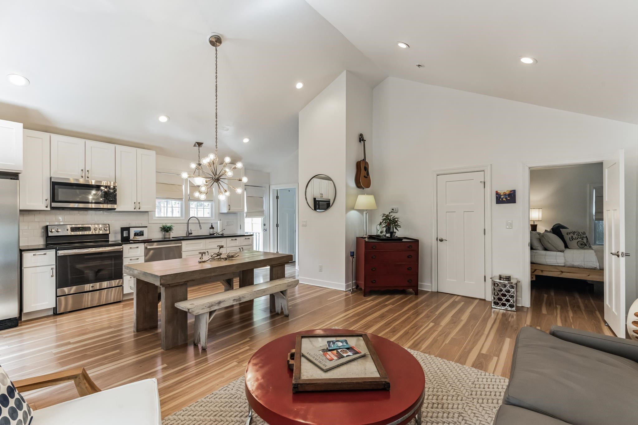 1203 North Miami Boulevard Durham, NC 27703 - Photo 6 of 22 a kitchen with stainless steel appliances granite countertop a stove a sink a refrigerator and a dining table with wooden floor
