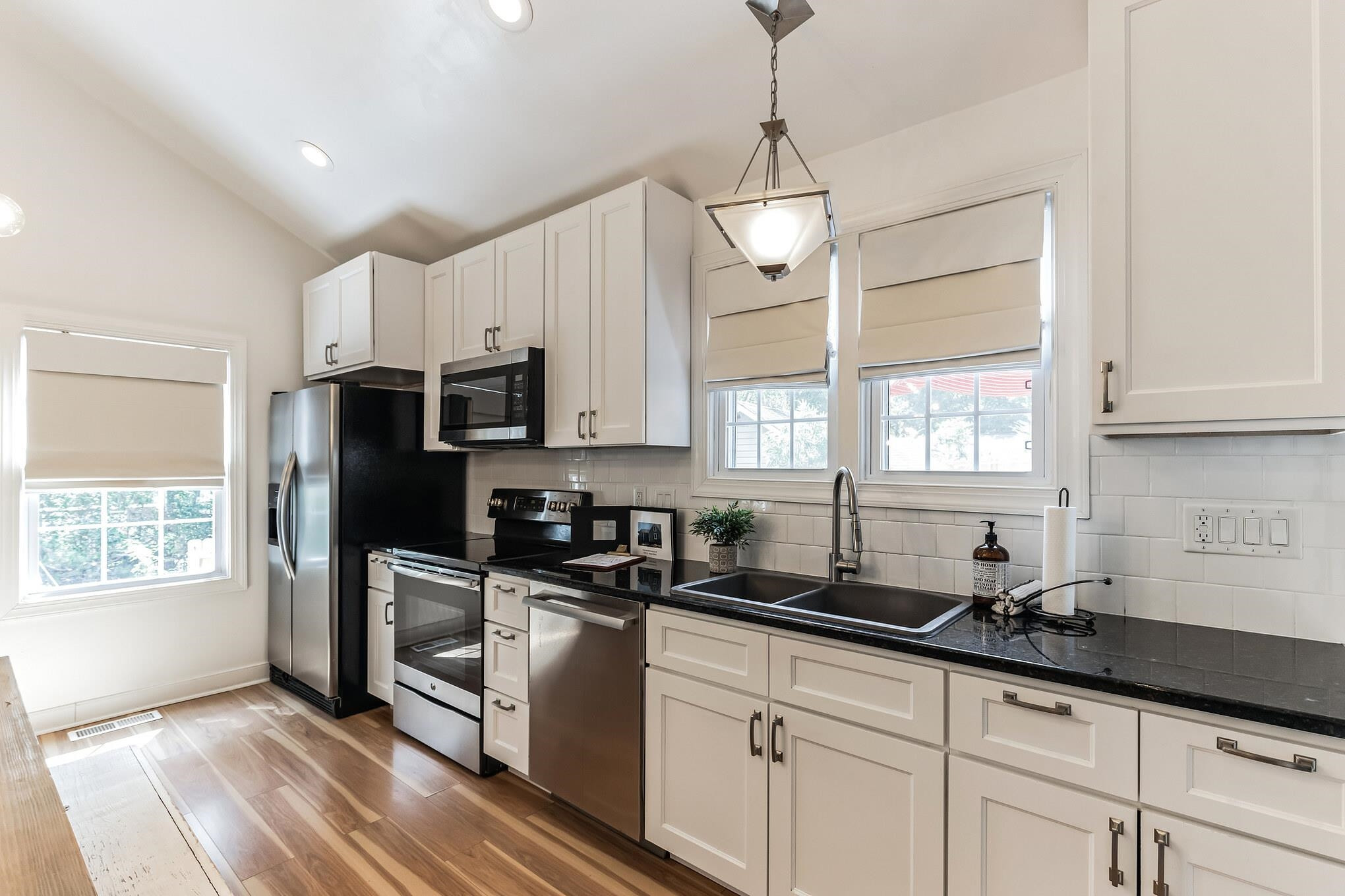 1203 North Miami Boulevard Durham, NC 27703 - Photo 8 of 22 a kitchen with granite countertop a sink stainless steel appliances and window