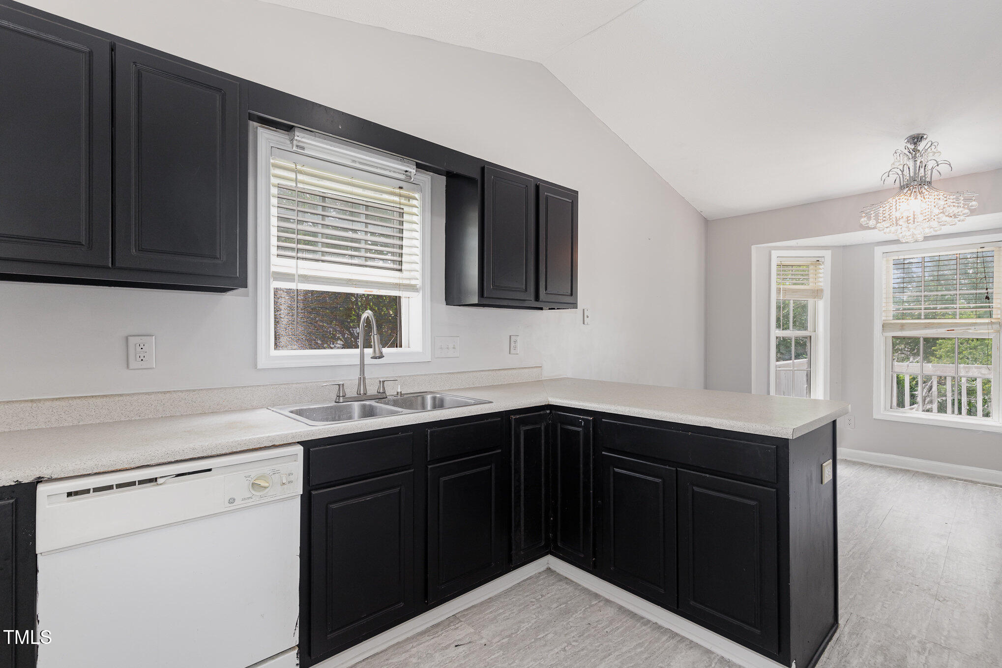 3485 Green Valley Road Fayetteville, NC 28311 - Photo 10 of 28 a kitchen with a sink dishwasher a stove and black cabinets