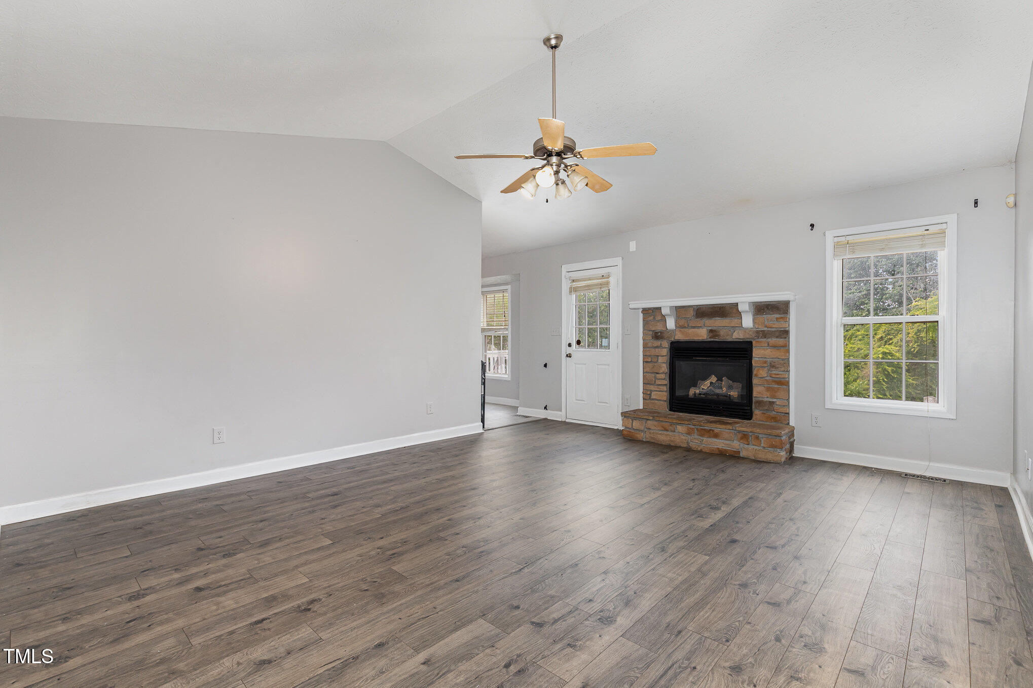 3485 Green Valley Road Fayetteville, NC 28311 - Photo 4 of 28 a view of empty room with wooden floor fireplace and a window