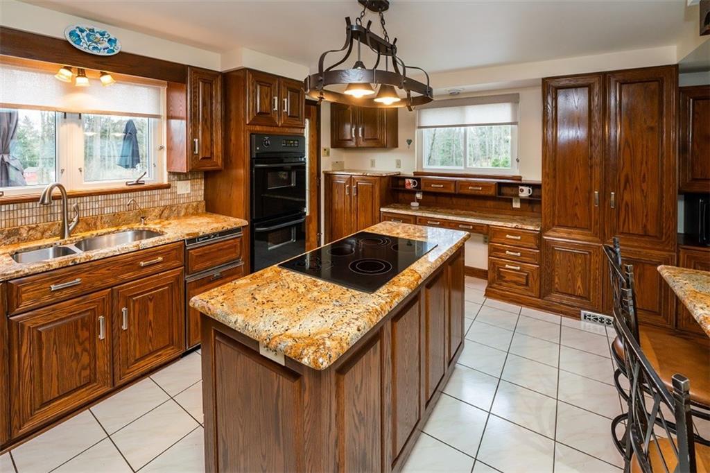 721 Rustic Lodge Road Indiana, PA 15701 - Photo 12 of 25 a kitchen with stainless steel appliances granite countertop a sink and a stove