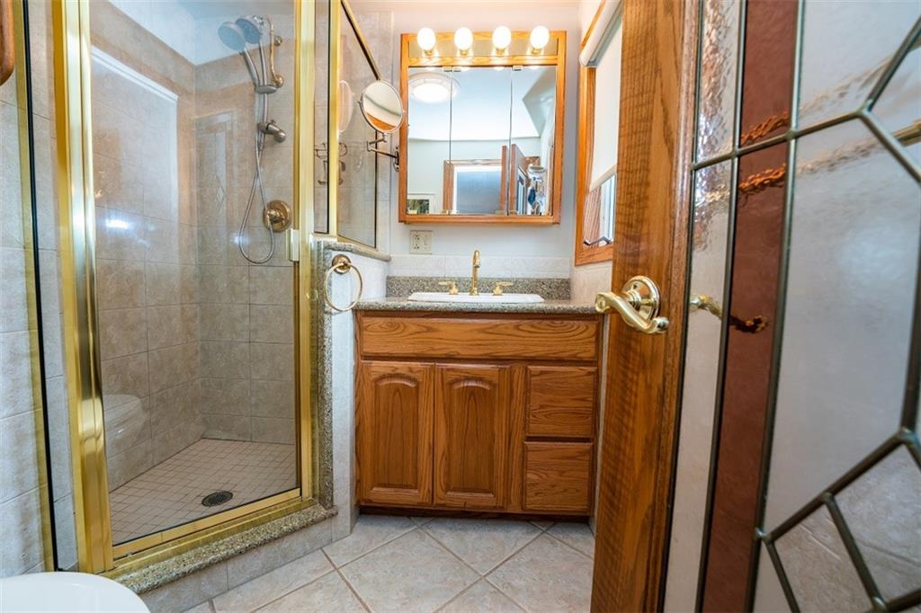 721 Rustic Lodge Road Indiana, PA 15701 - Photo 19 of 25 a bathroom with a granite countertop sink a mirror and a shower