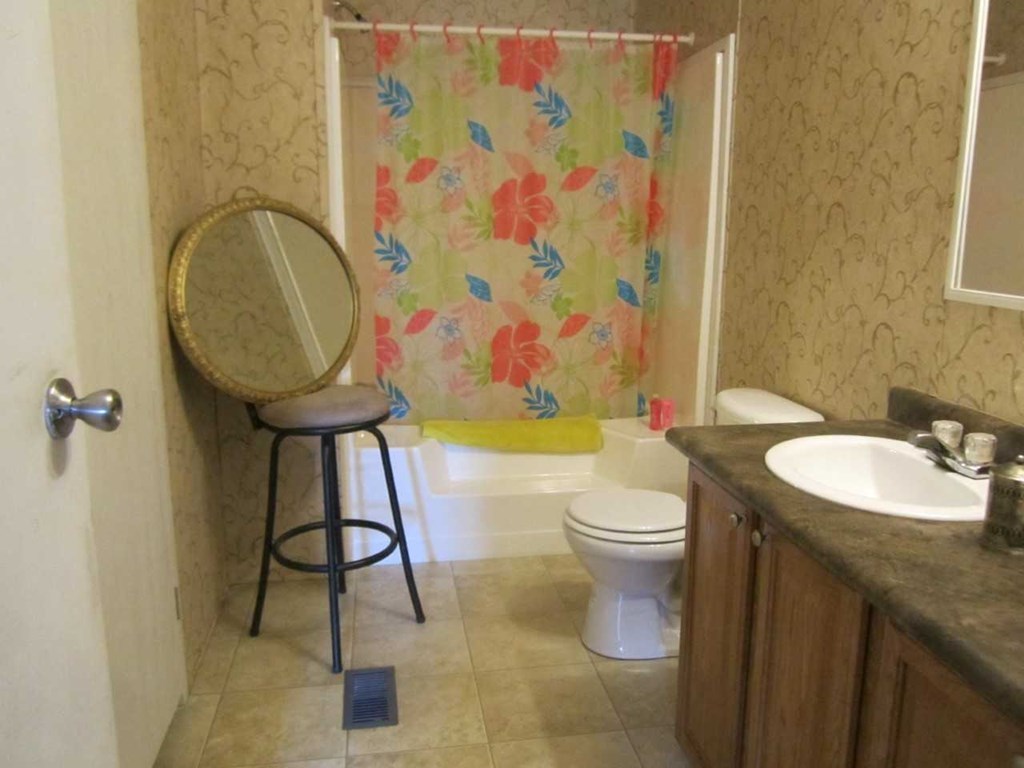 148 5th Road, Unit 20 Haddock, GA 31033 - Photo 6 of 12 a bathroom with a toilet sink and mirror