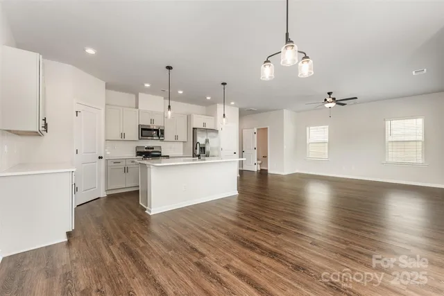 a view of kitchen and kitchen with wooden floor