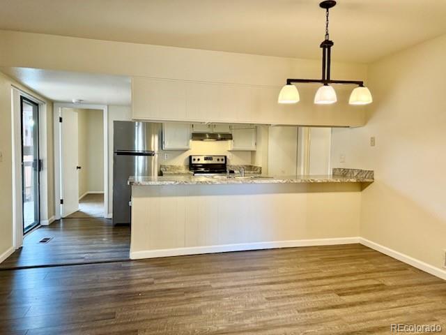 a view of a kitchen with wooden floor and a ceiling fan