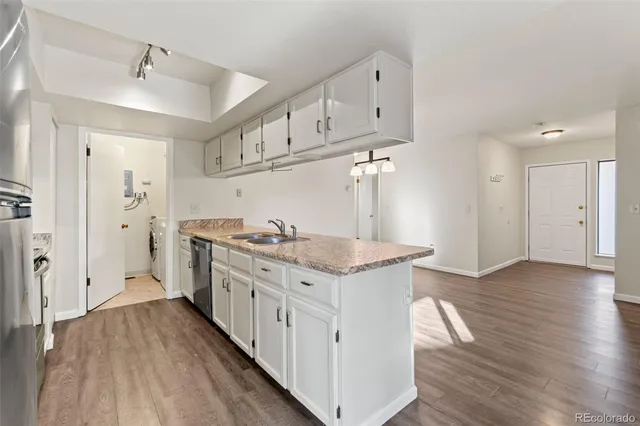 a kitchen with stainless steel appliances granite countertop a stove and cabinets