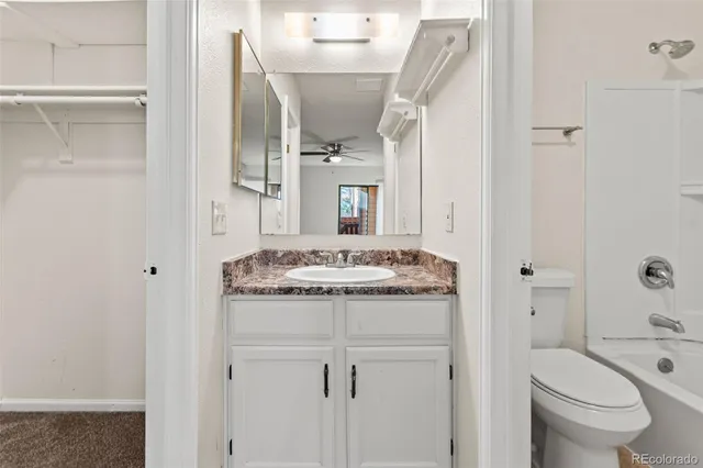 a white toilet sitting next to a bath tub