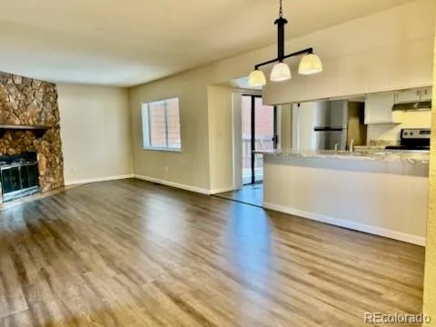 a view of a kitchen with furniture and wooden floor