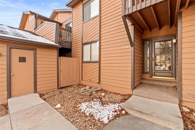 a view of a house with snow on the road