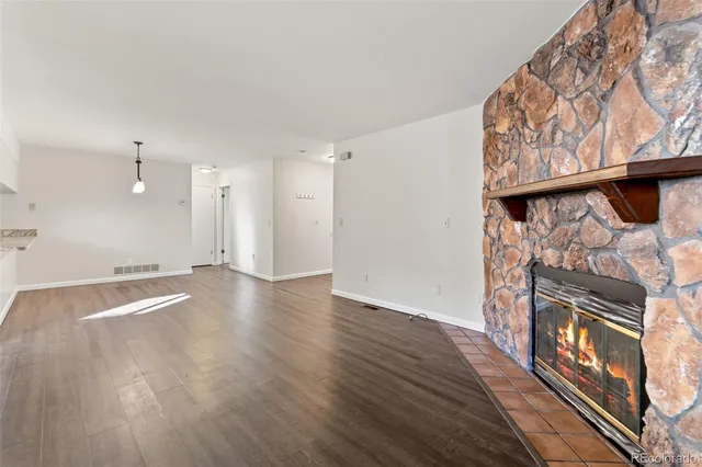 a view of a room with wooden floor and white walls