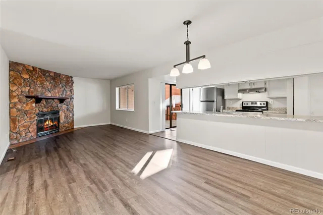 a kitchen with stainless steel appliances granite countertop a refrigerator and a sink