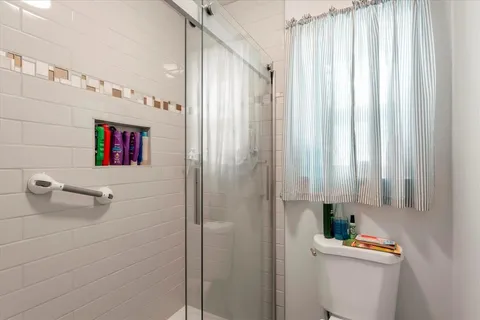 a bathroom with a shower and a sink