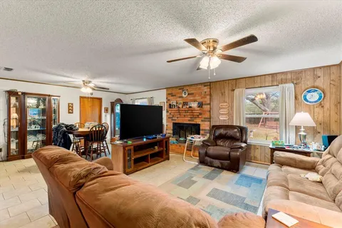 a living room with furniture and a flat screen tv with wooden floor