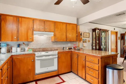 a kitchen with stainless steel appliances a sink cabinets and wooden floor