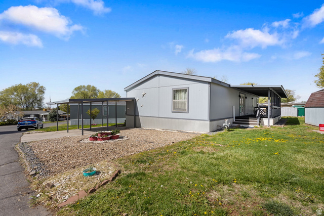 2600 North Hill Field Road, Unit 86 Layton, UT 84041 - Photo 23 of 25 View of home's exterior with a lawn and driveway