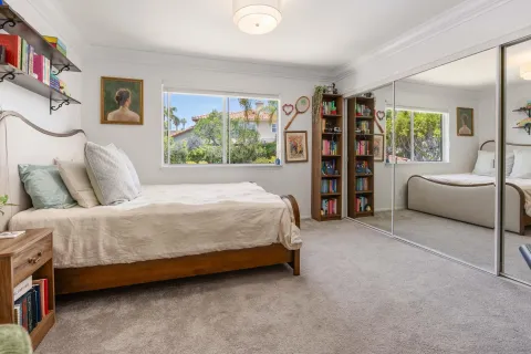 a bed room with a bed and a chair