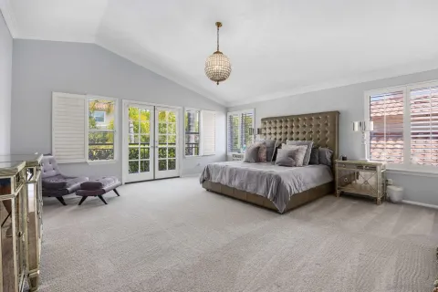 a bedroom with bed couch and window
