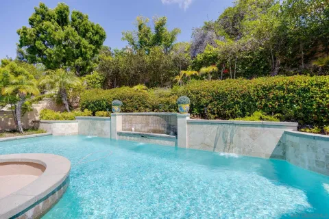 a view of a backyard with swimming pool