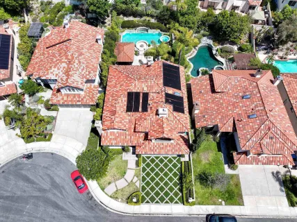 an aerial view of a house with a yard basket ball court and outdoor seating