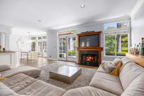 a living room with furniture large window and a fireplace