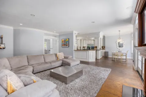 a living room with furniture and view of kitchen