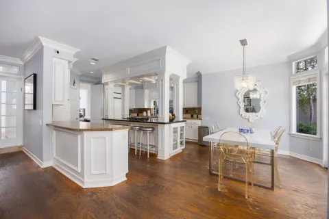a large kitchen with white cabinets and stainless steel appliances