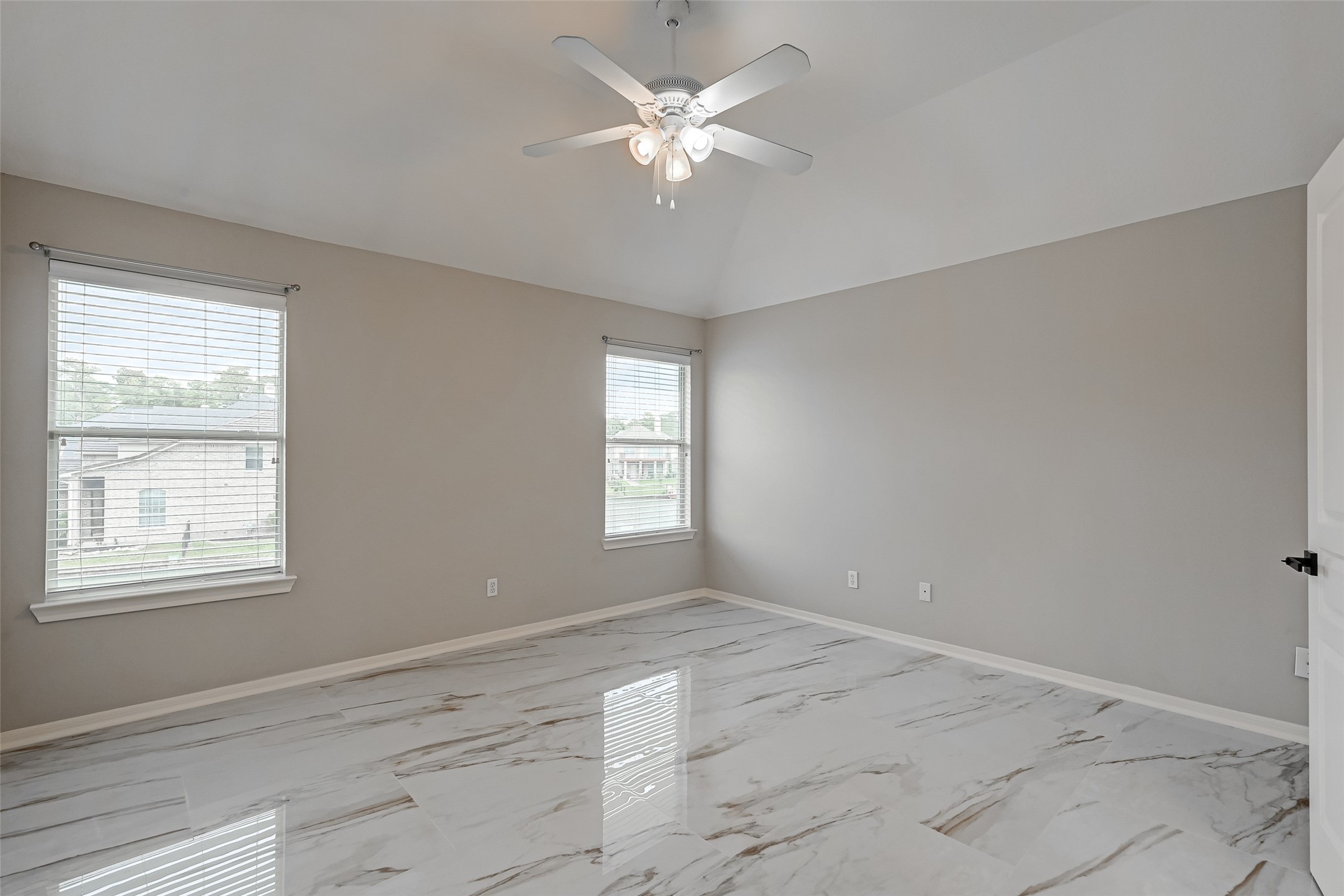 11954 Galentine Point Cypress, TX 77429 - Photo 19 of 48 a view of an empty room with window and chandelier fan