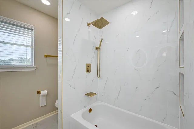 a bathroom with a bathtub and a shower