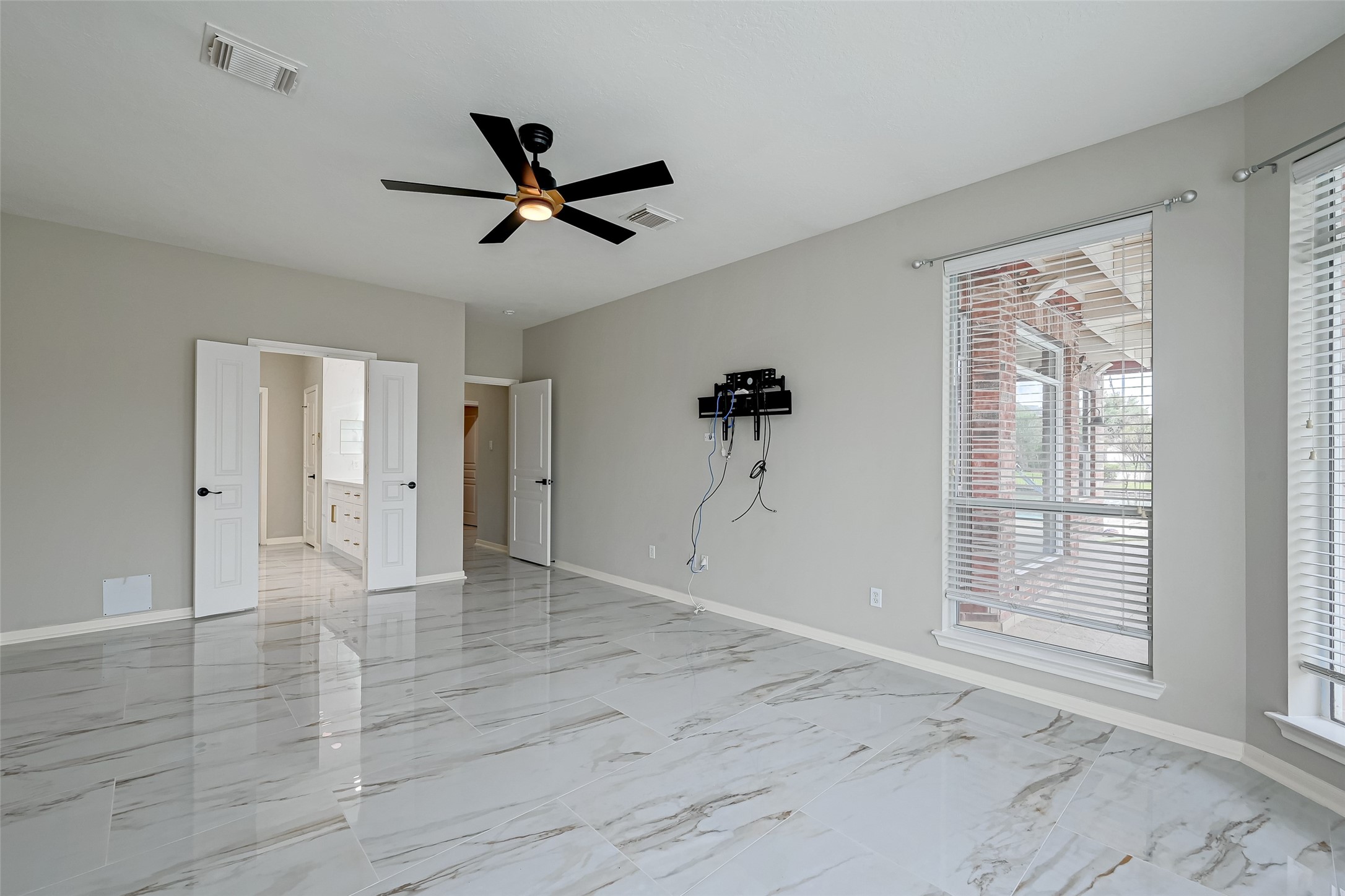 11954 Galentine Point Cypress, TX 77429 - Photo 31 of 48 a view of empty room with wooden floor and fan