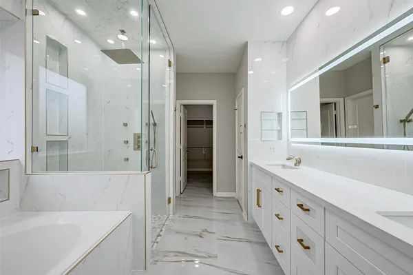 a bathroom with a tub sink and a mirror