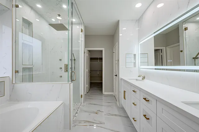 a bathroom with a tub sink and a mirror