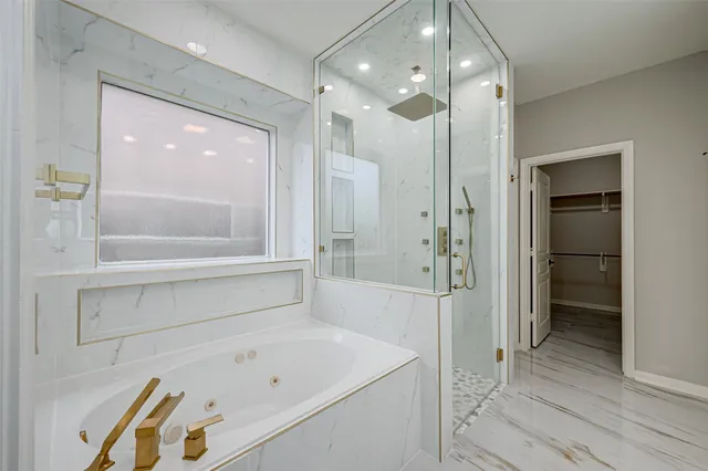 a bathroom with a tub shower vanity and a sink
