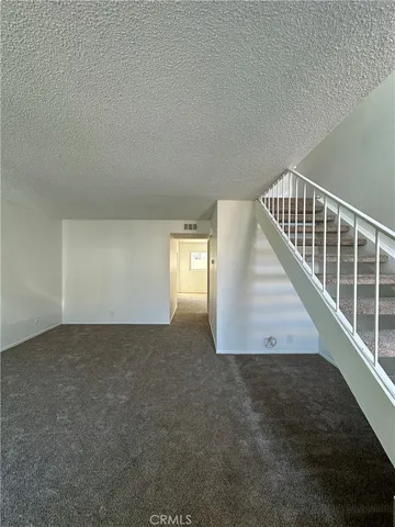 a view of an empty room and a window