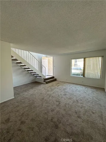 a view of an empty room with stairs