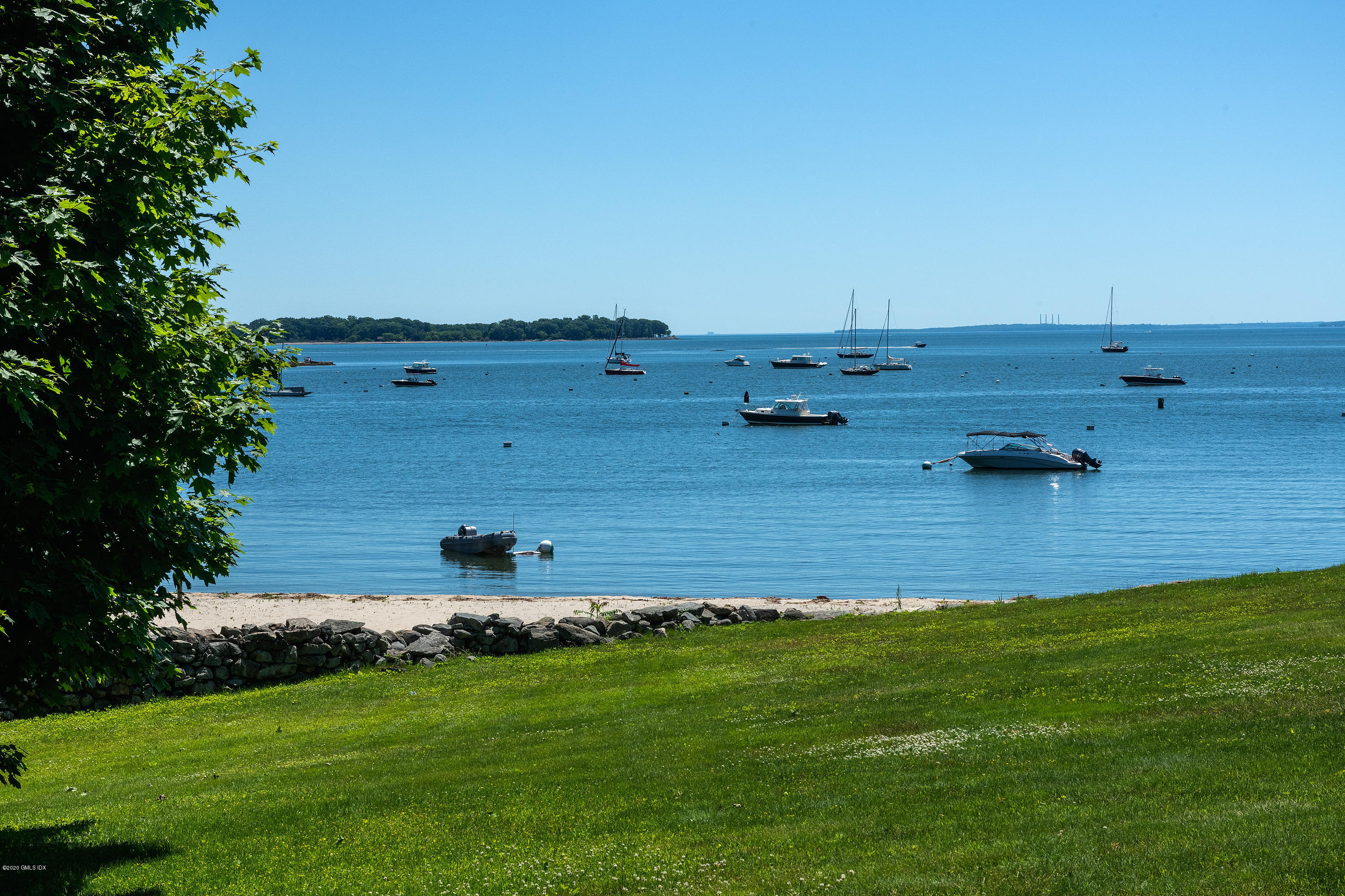 140 Field Point Circle Greenwich, CT 06830 - Photo 11 of 19 a view of a lake with a house in the background
