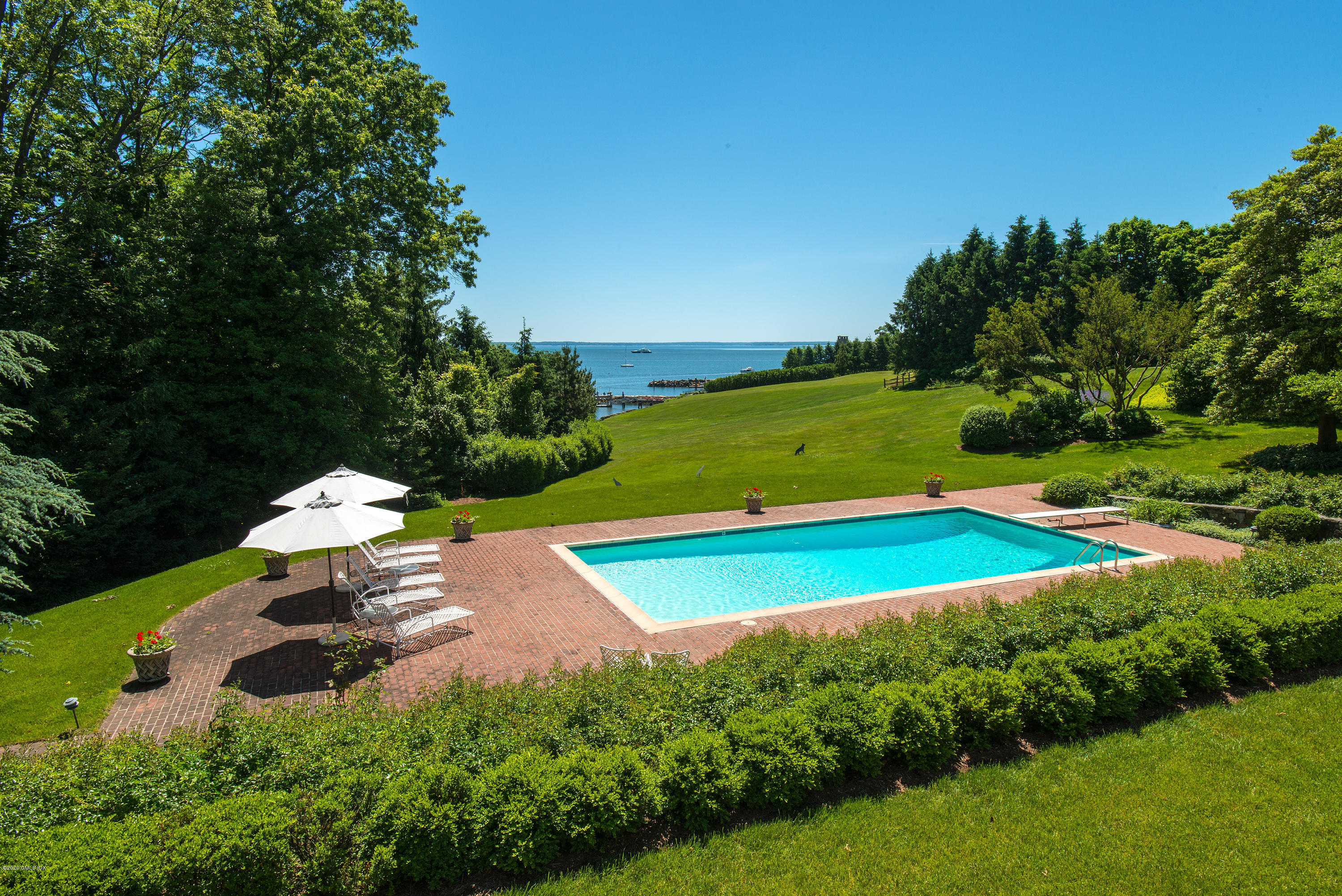 140 Field Point Circle Greenwich, CT 06830 - Photo 4 of 19 a view of a backyard with swimming pool