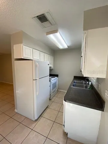 a kitchen with a refrigerator and a stove