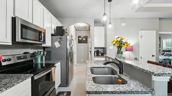 a kitchen with a sink stove and microwave